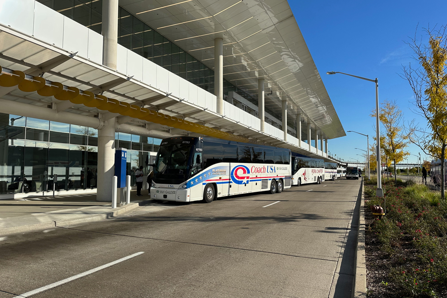 Three long-distance buses are loading passengers at O'Hare's intermodal center.