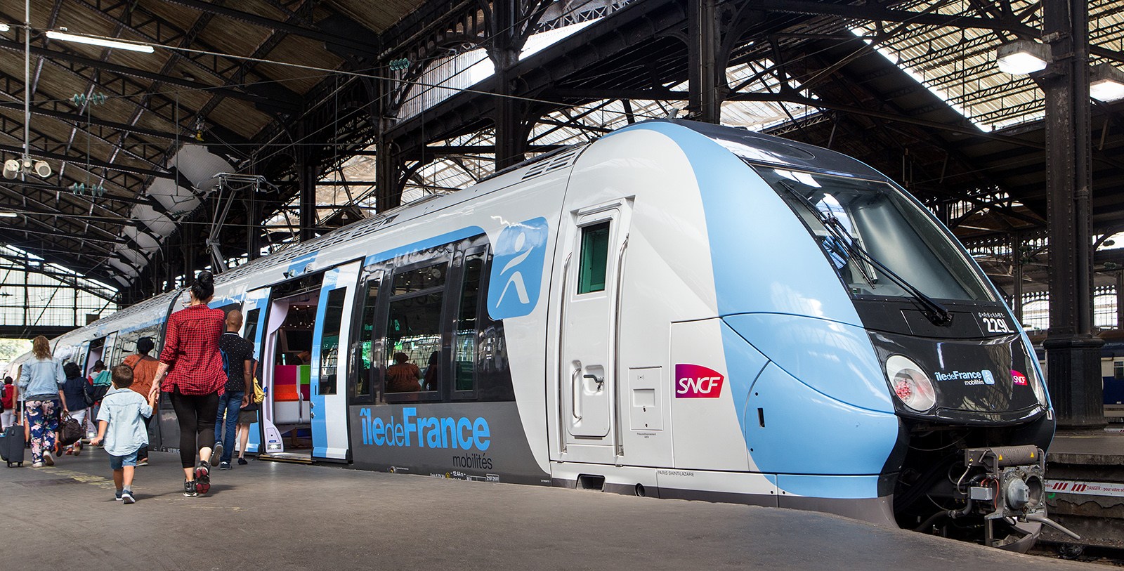 Passengers are boarding a regional train at Gare de Paris Saint Lazare.