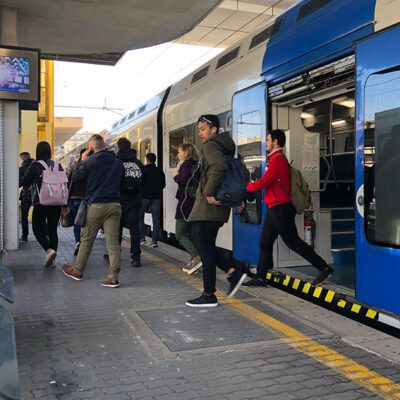 People are exiting a regional train in Rome.