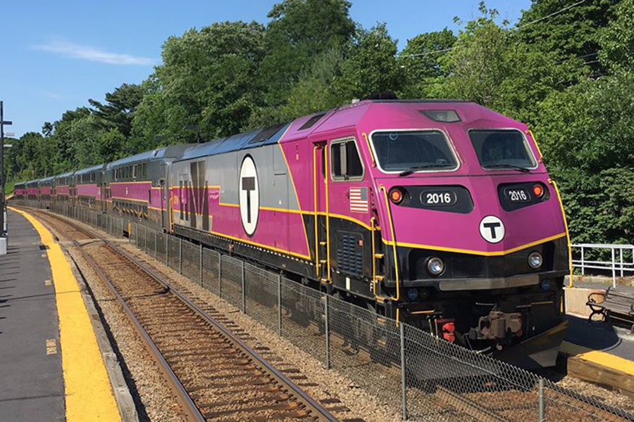 An MBTA locomotive pulling into a station.