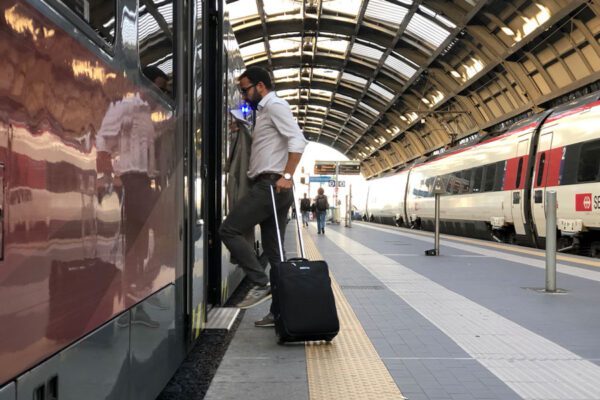 man boarding train at airport