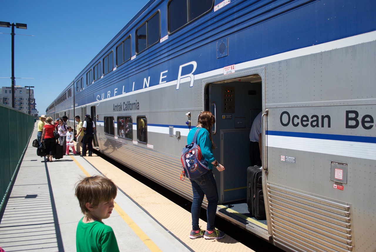 A woman is boarding an Amtrak Surfliner in Oceanside, CA