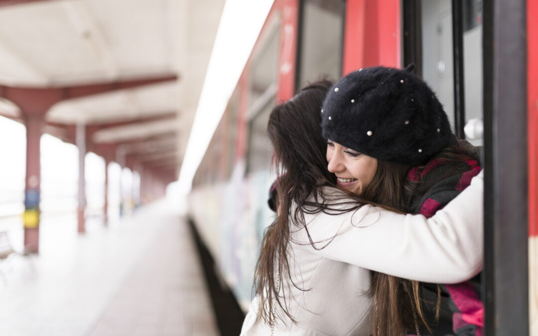 Attractive tourist receiving a goodbye hug