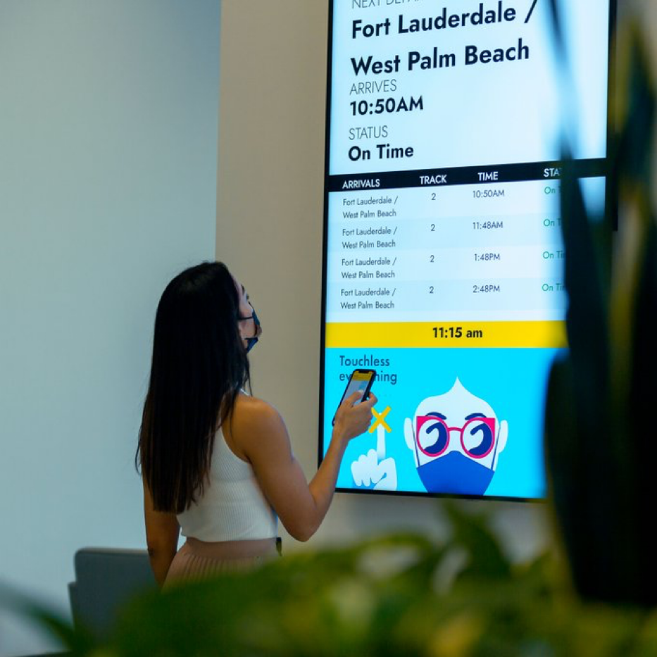 Brightline_Woman_departure_Board