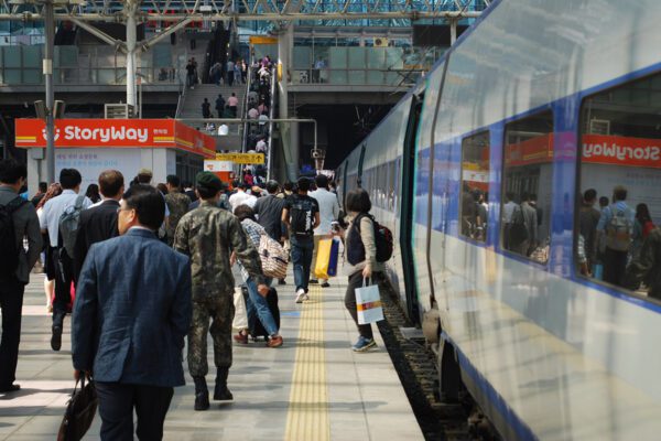 The platform at Seoul central station is busy with people getting off the train.