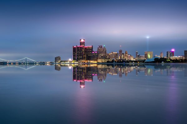 Detroit Skyline at night, with river in foreground.