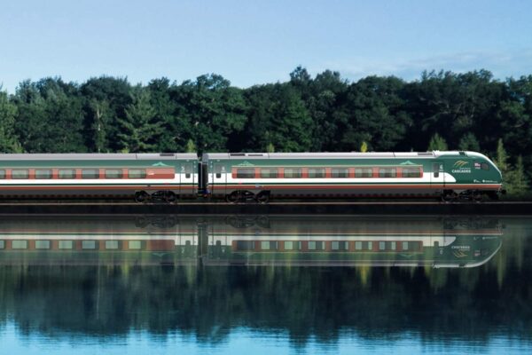 Train traveling next to a body of water
