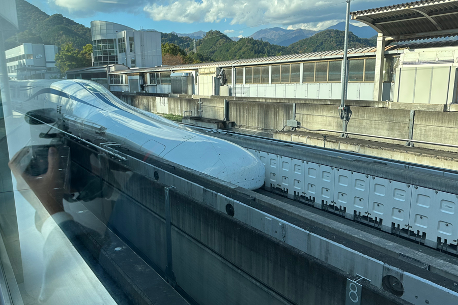 A SC Maglev test train is pulling into the station in Japan.