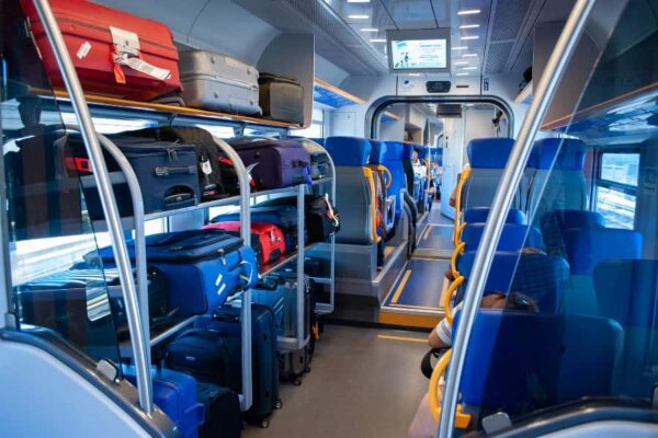 Airport Train Interior shot showing large luggage racks.