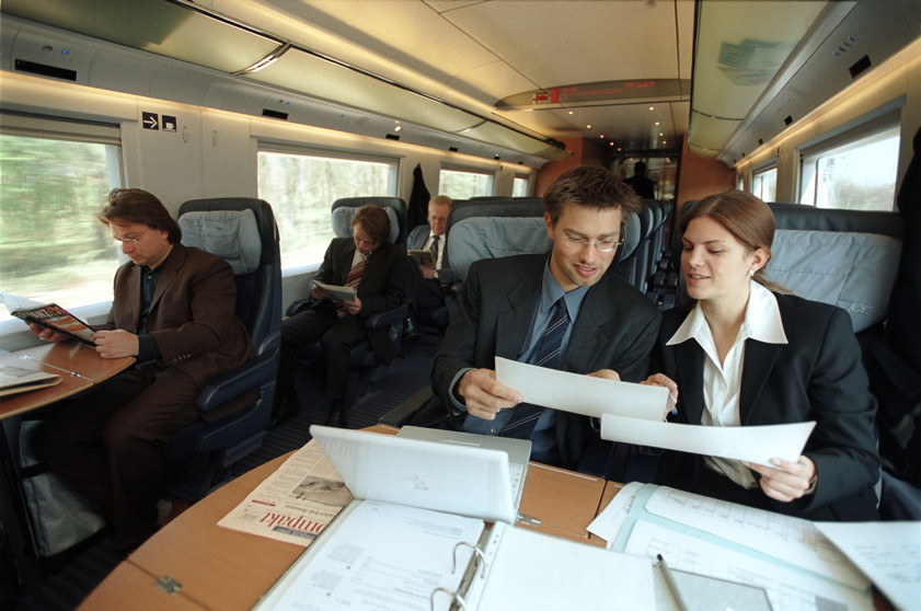 Two people are having a meeting on a train.