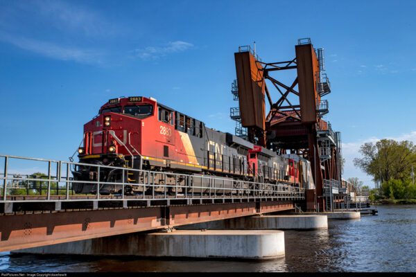 A CN frieght train is crossing the Fox River in Oshkosh, WI