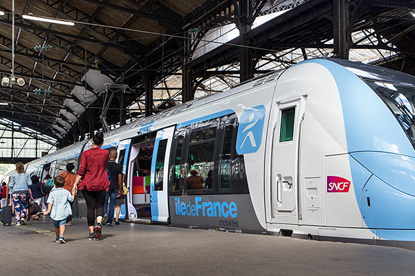 Passengers are boarding a regional train at Gare de Paris Saint Lazare.