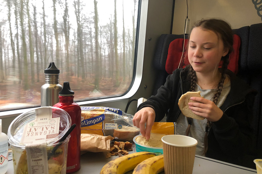 Greta Thornberg eating lunch on a train.