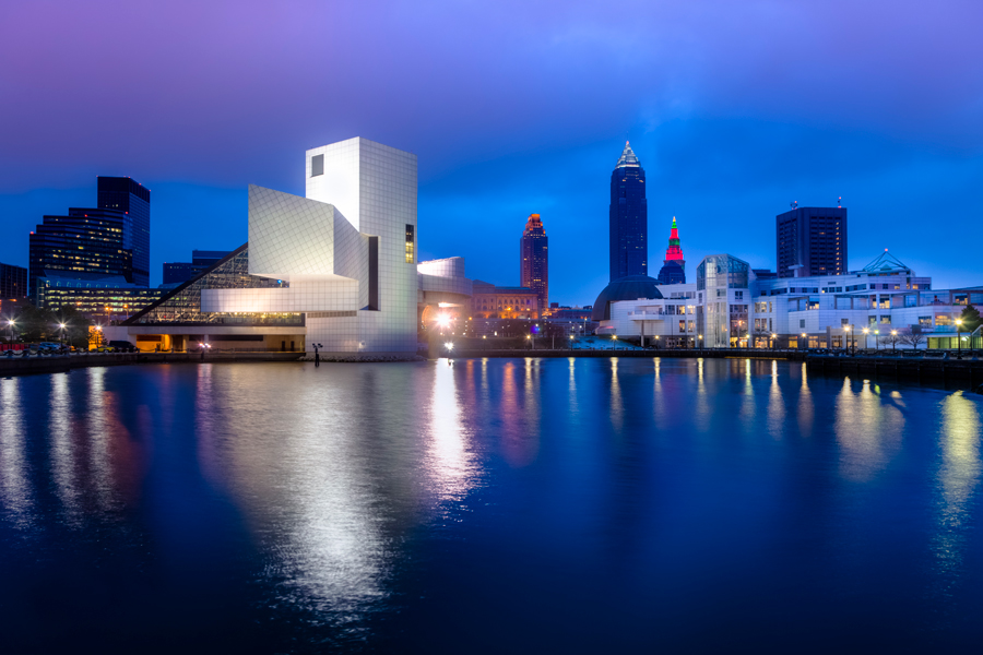 The Rock and Roll hall of fame is in the foreground, the Cleveland skyline is in the background.