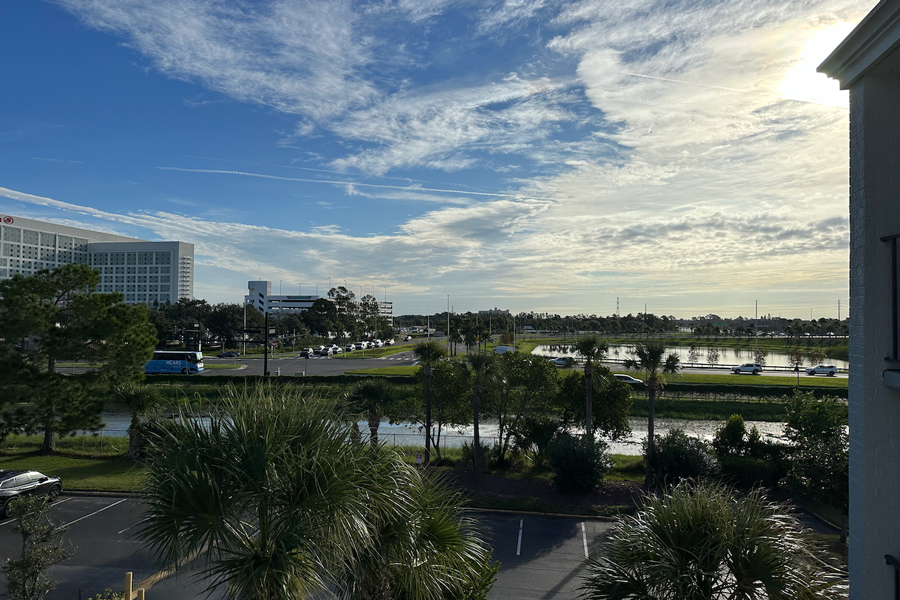 There is a hotel building to the right of frame, and a large parking garage next to it.  A transit bus station is not visible but is in the frame.  Brightline's Convention Center/Universal Studios station will be next to the bus station. 