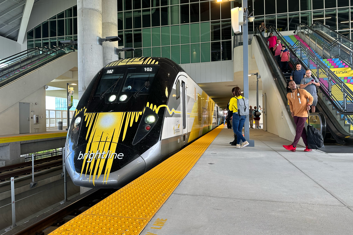 A Brightline train is boarding passengers in the Orlando station.