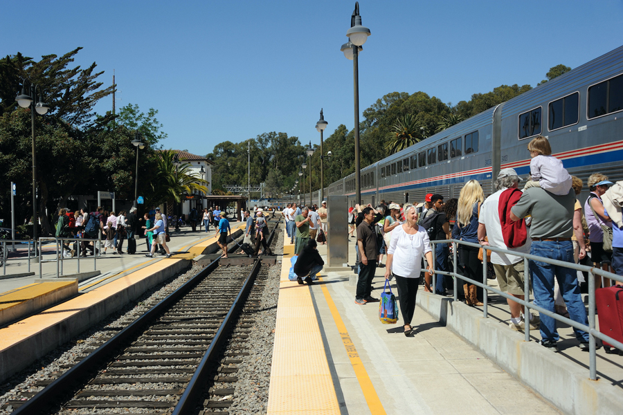 A crowd is waiting to board an Amtrak train in CA.