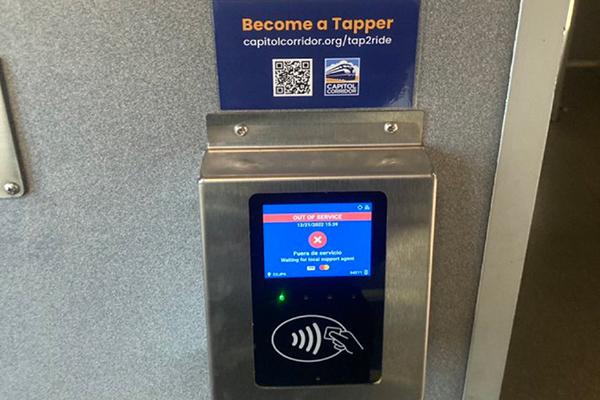 A credit card reader in the vestibule of a Capitol Corridor train for tap-on fare payment.