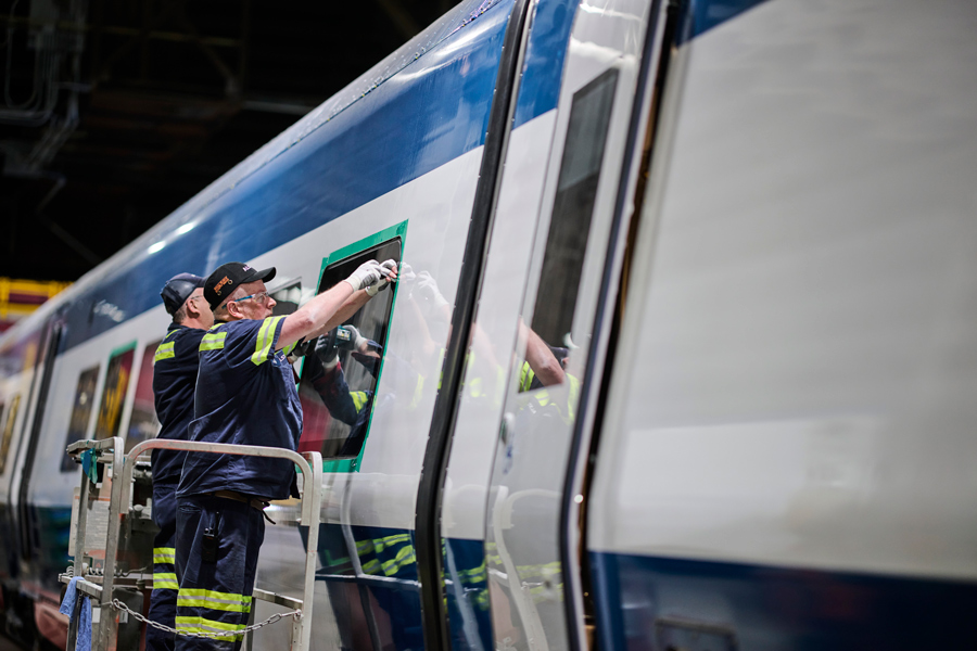 Acela_Next_Gen_Window-assembly_Alstom-Amtrak_900x600 Two workers are installing a window on an Acela Next-Gen transet.