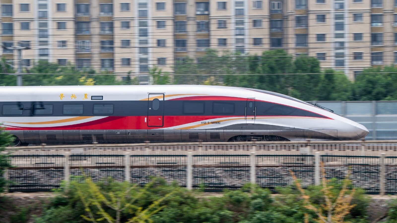 A red, white, and gold CR400BF "Golden Phoenix" high-speed train running in China