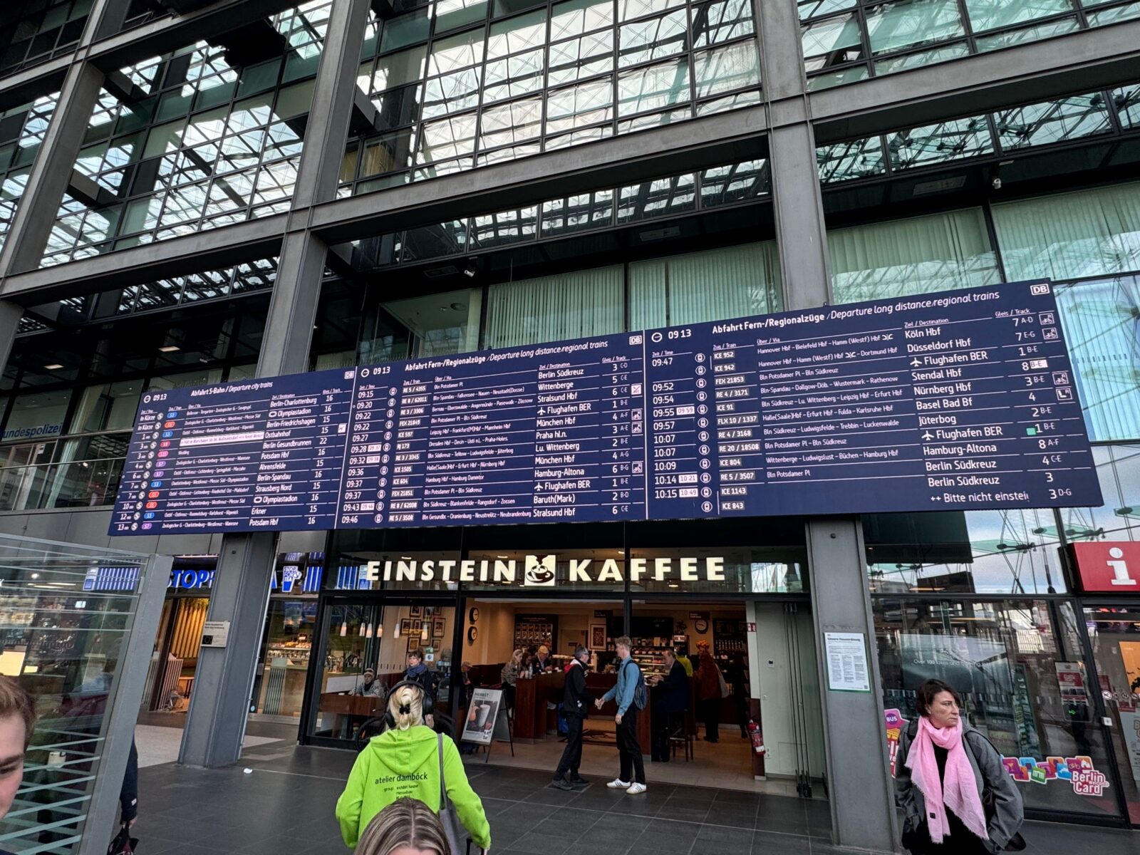 A large dark blue departure board at Berlin Central Station in Germany